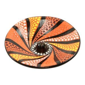 Porte-encens en terre cuite orange avec des points et un design en spirale